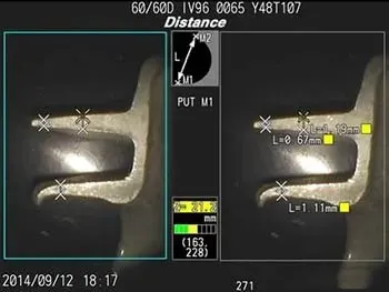 Interfaz de medicion de RVI en 3d del Iplex Captura de pantalla de la interfaz de medición estereoscópica del videoscopio IPLEX. Muestra el cálculo de distancia submilimétrica ('Distance') entre dos puntos (M1 y M2) en un componente metálico. Ejemplo práctico de Inspección Visual Remota (RVI) con mapeo de superficie y nube de puntos para control de calidad NDT.